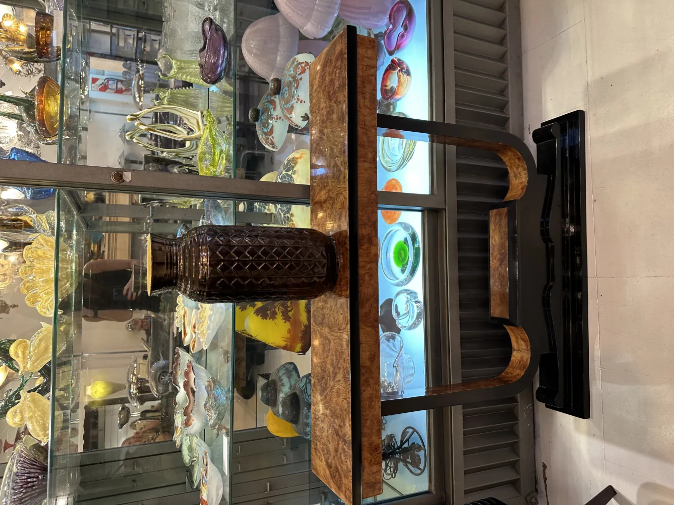 Antique ceramic vase with geometric shapes, variety of objects in background