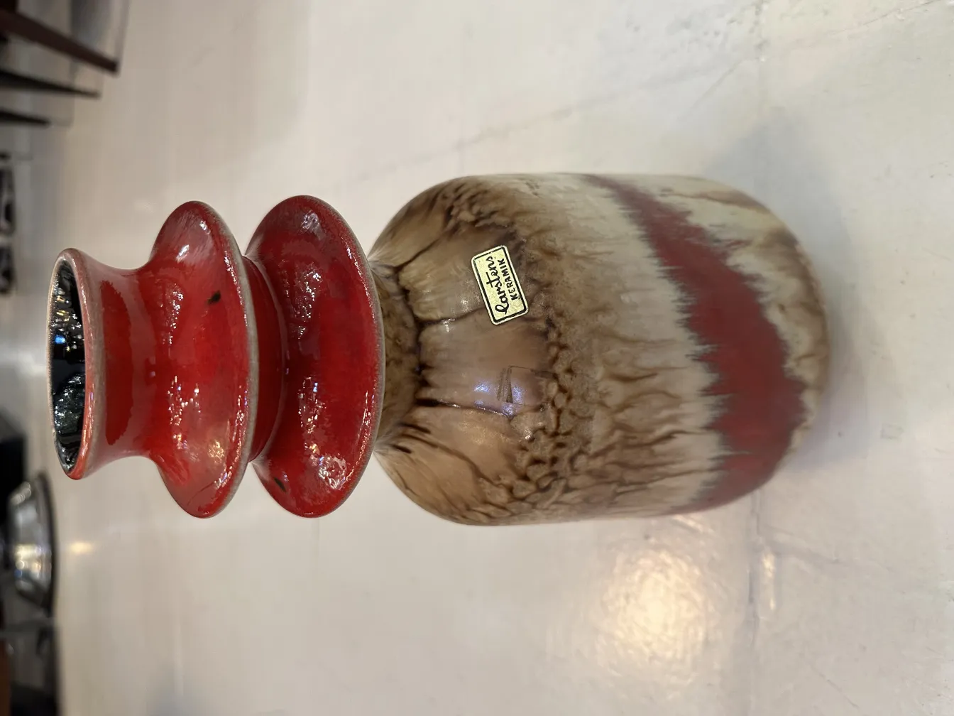 vaso decorativo antigo de cerâmica com detalhes vermelhos.