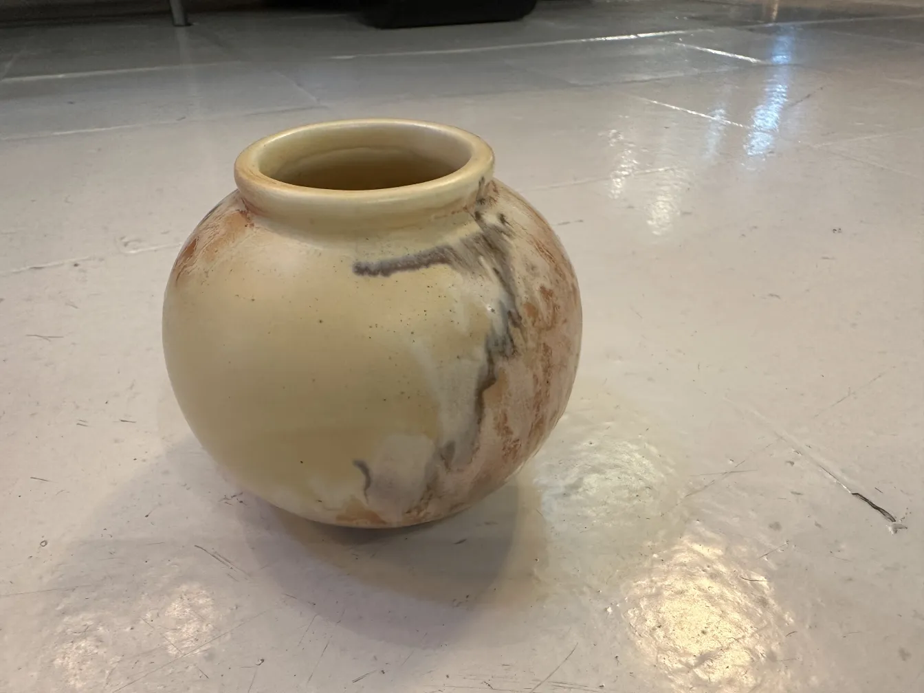 Antique ceramic vase in cream tones with irregular design