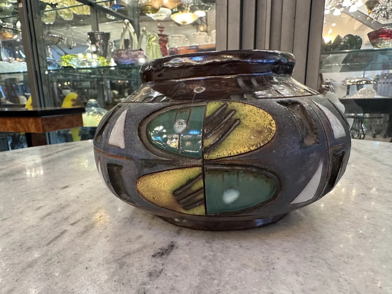 Vaso de cerâmica antiga com design decorativo, estilo artesanal, cores vibrantes.