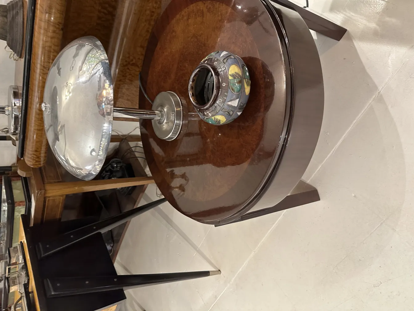 silberne Lampe auf einem Tisch mit dekorativer Keramik