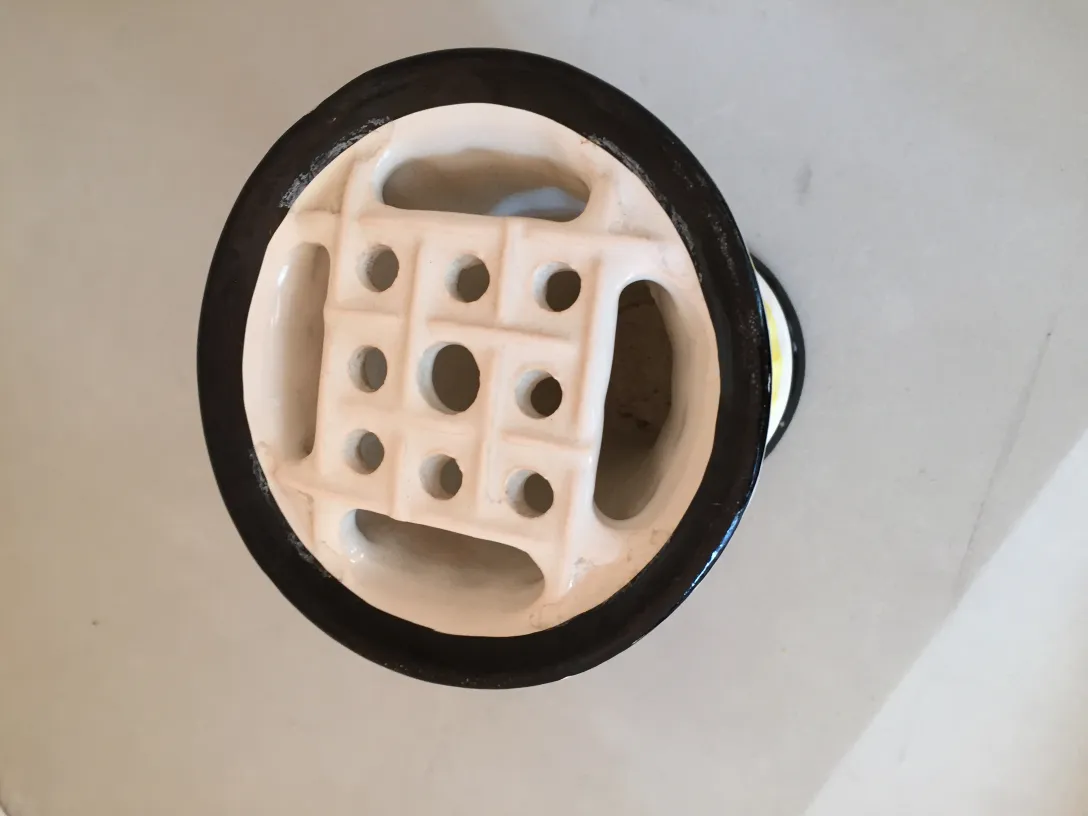 Unique shaped ancient ceramic decorative item with holes.