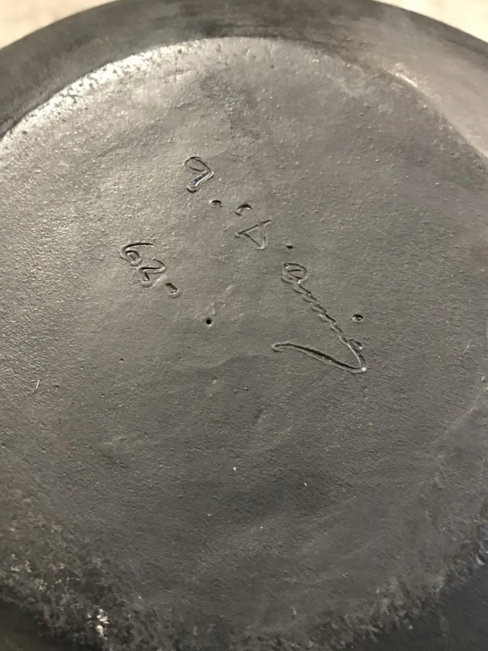 Antique artisan ceramic, dark background with signature