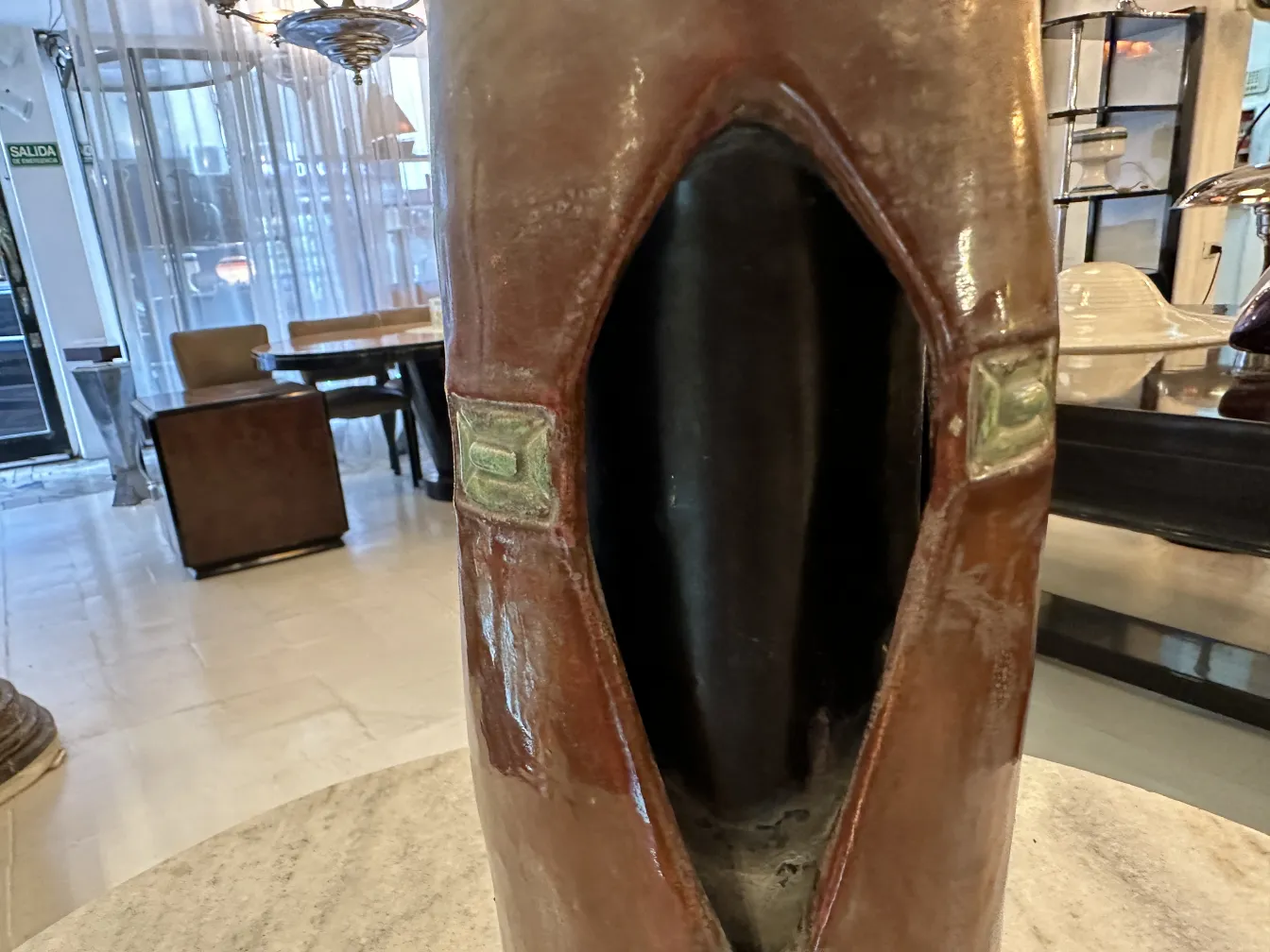 Close-up of an antique ceramic with unique details and textures in a modern setting.