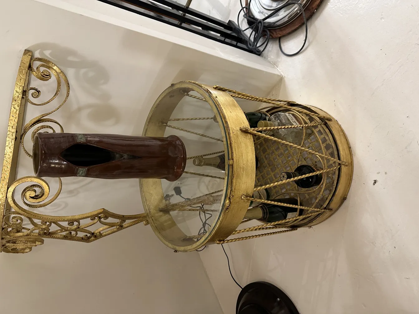 Antique ceramic vase on a table with golden base.