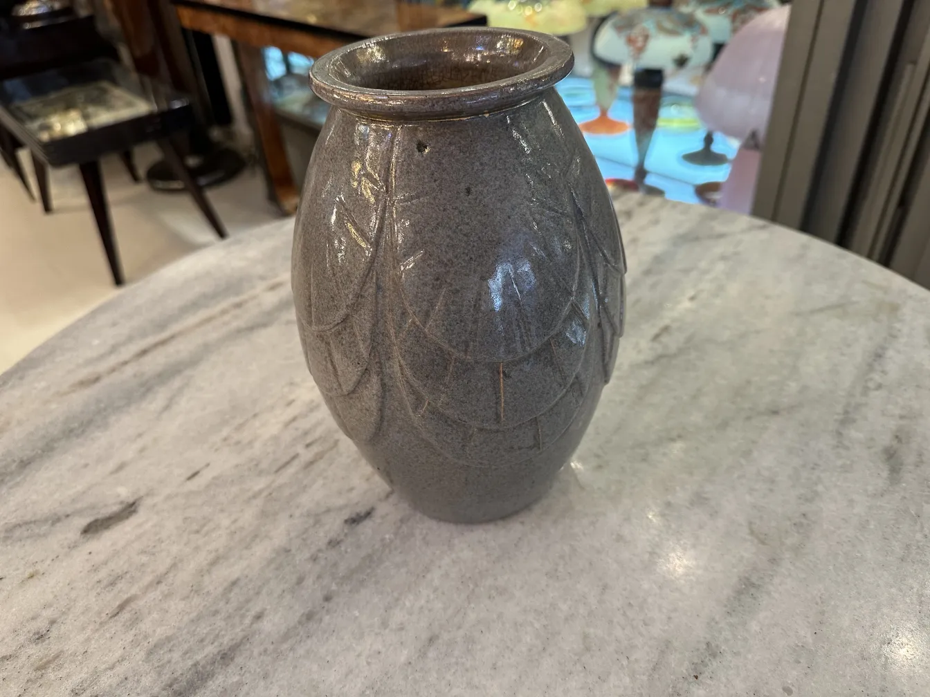 Antique ceramic vase with relief design, light gray.