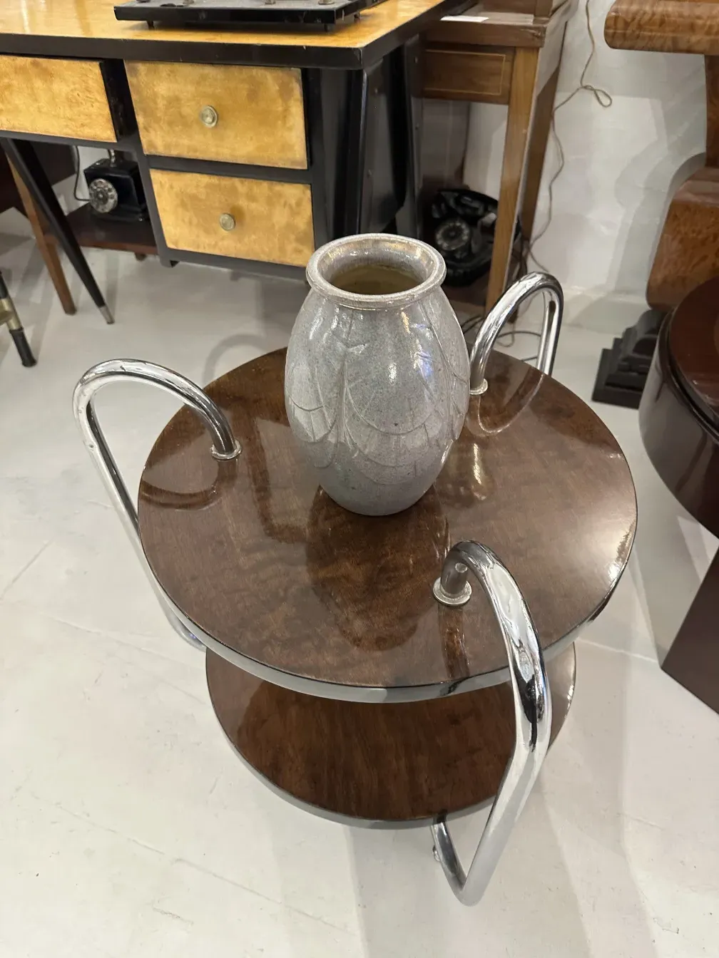 An antique Bourguet ceramic piece with elegant design on a vintage table.