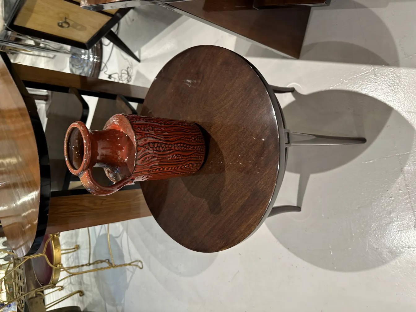 Antique ceramic jug with textured design on a table