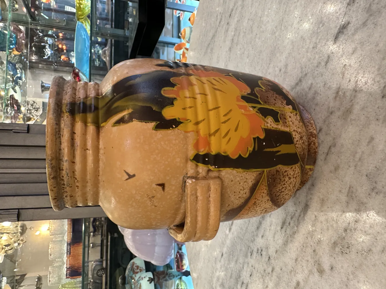 Antique ceramic vase with warm colored flowers