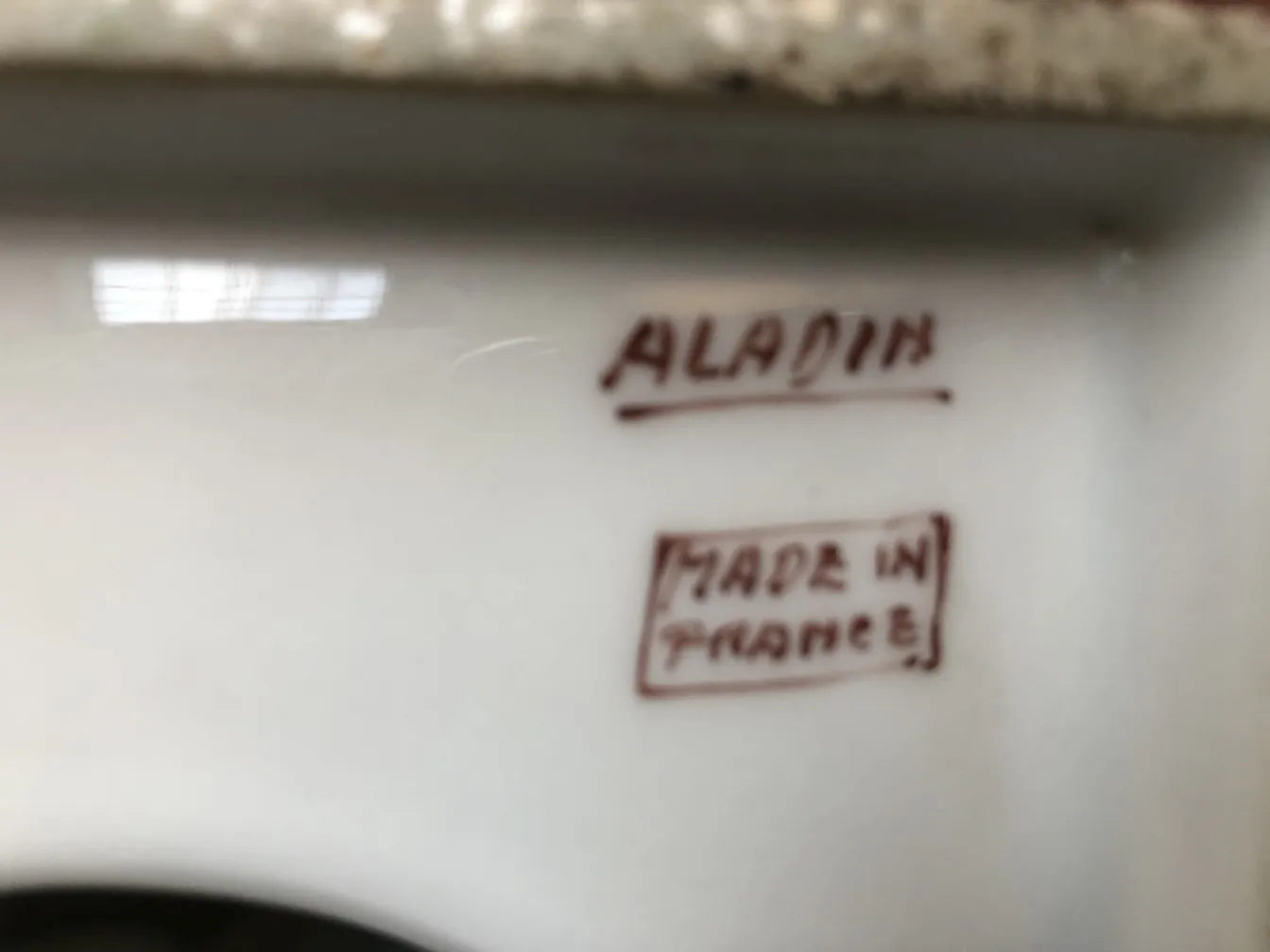 Ancient Aladin ceramic with visible markings on base.