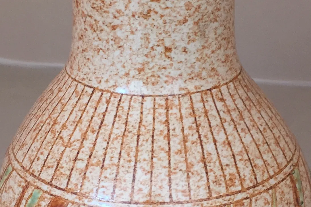 Antike Keramikwelle mit gestreiftem Design und sanften Farben.