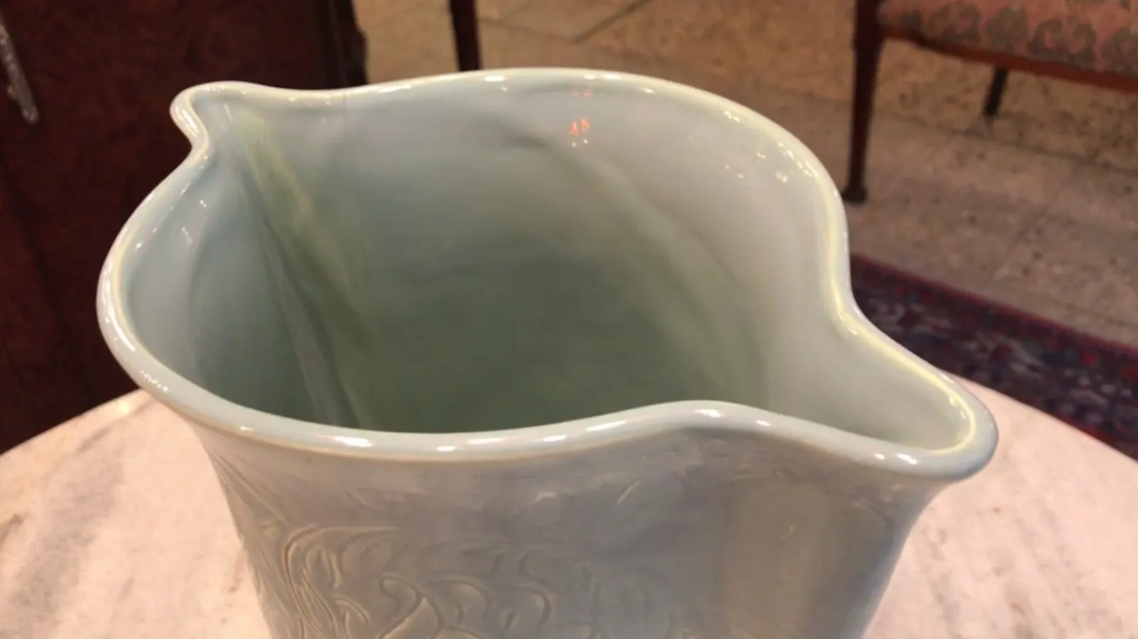 Interior of an antique blue ceramic with wavy edges