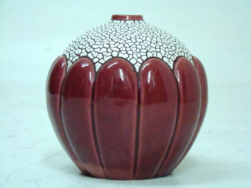 Antique ceramic with a curved edge in red color
