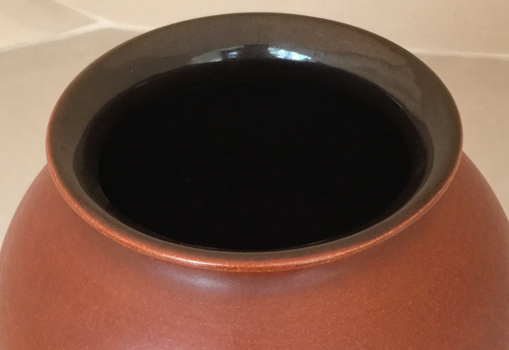 Antique Scheurich ceramic with black rim and terracotta color.