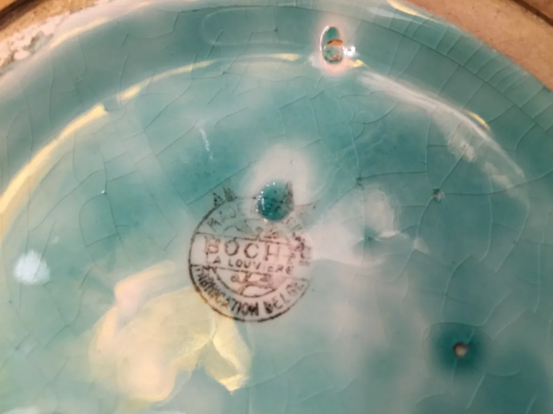 Antique ceramic plate glazed in blue with details.