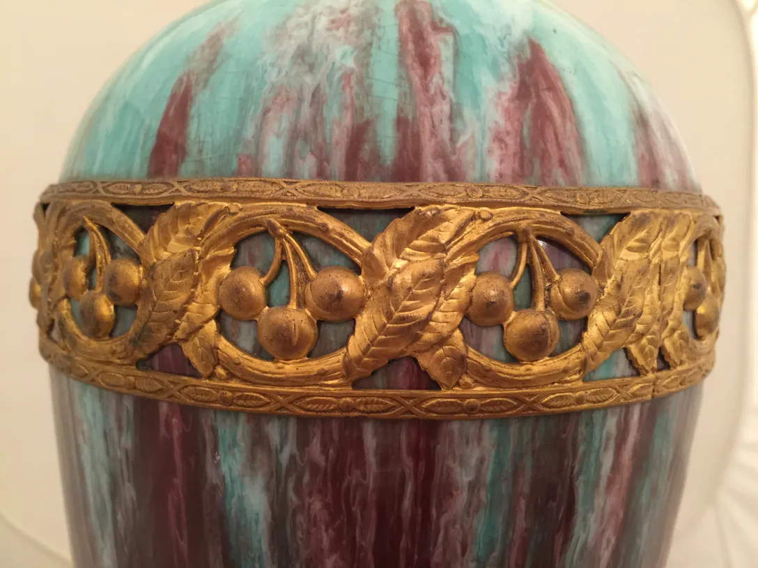 Antike Keramik mit goldenem Ornamentdesign und lebhaften Farben in einem klassischen Ambiente.