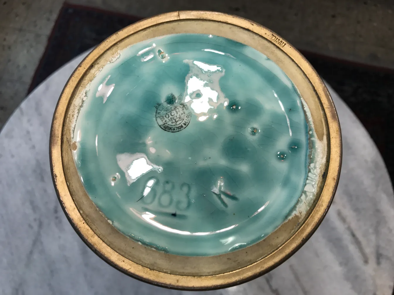 Detail of the underside of an antique ceramic with blue glaze.