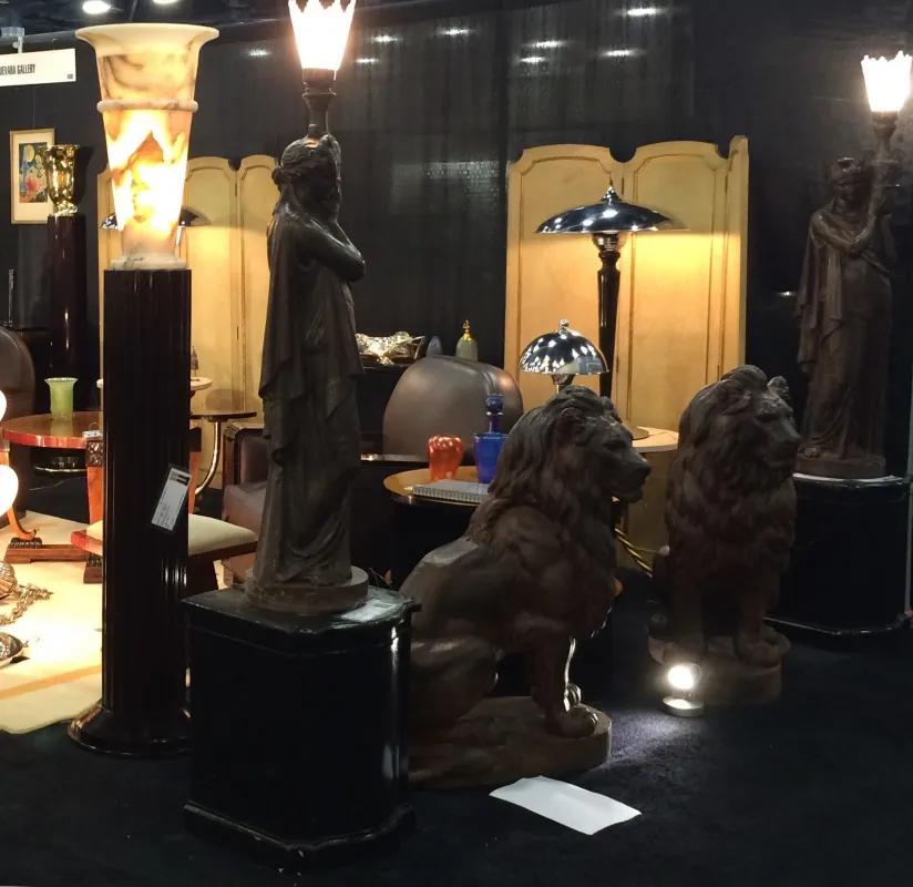 antique lion sculpture among other antiques