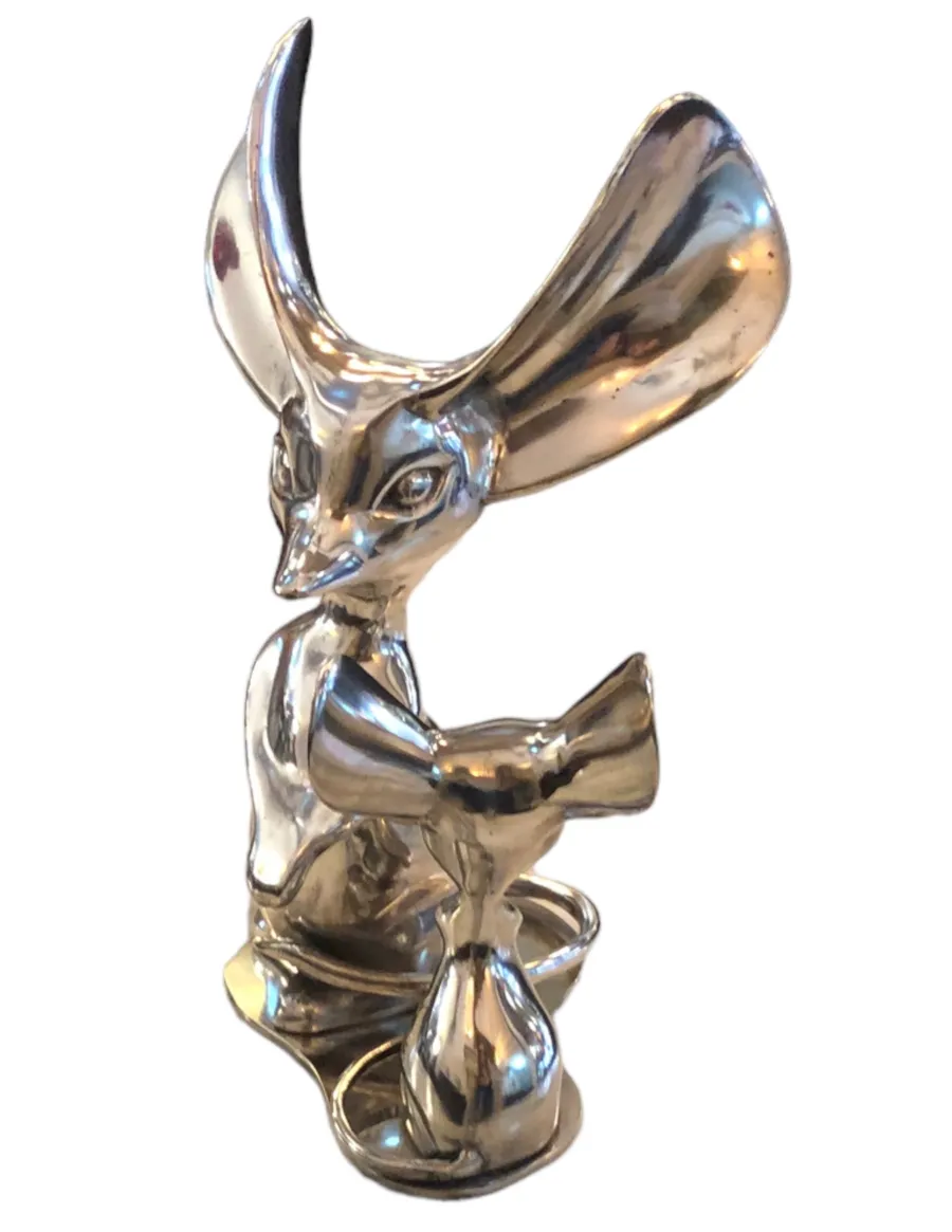 escultura antiga de um animal com orelhas grandes e brilhantes