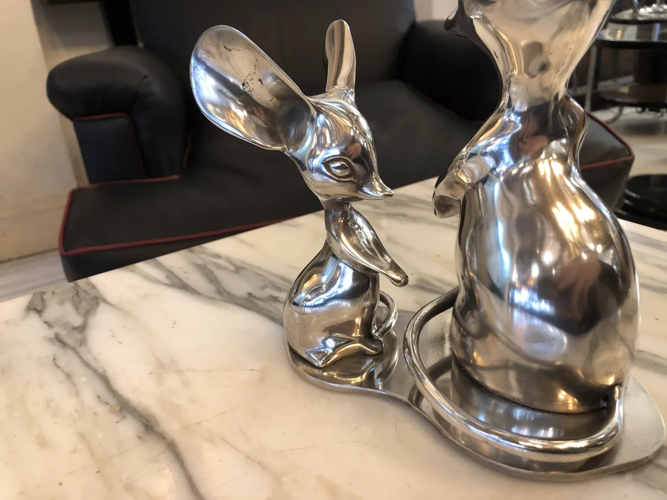 Antique sculpture depicting an animal, shiny and stylized.