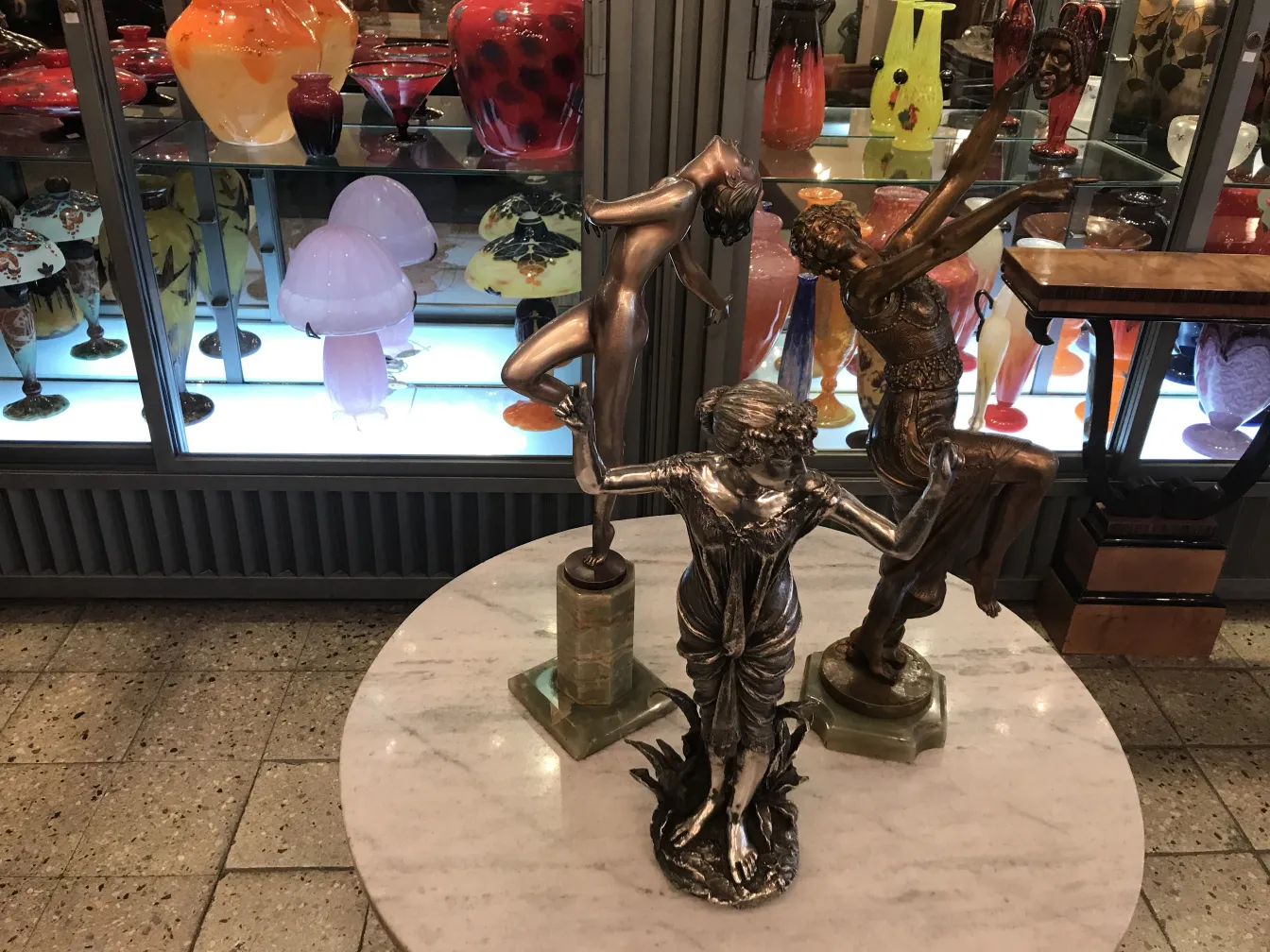 Three ancient sculptures in a diverse artistic setting