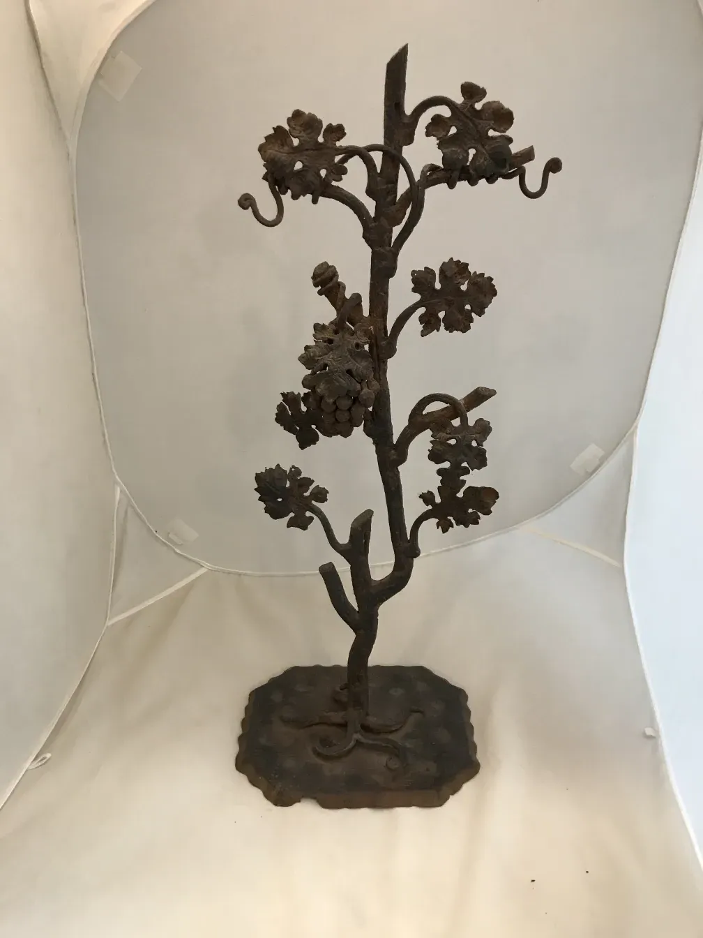 Ancient sculpture of a tree with detailed leaves and branches.