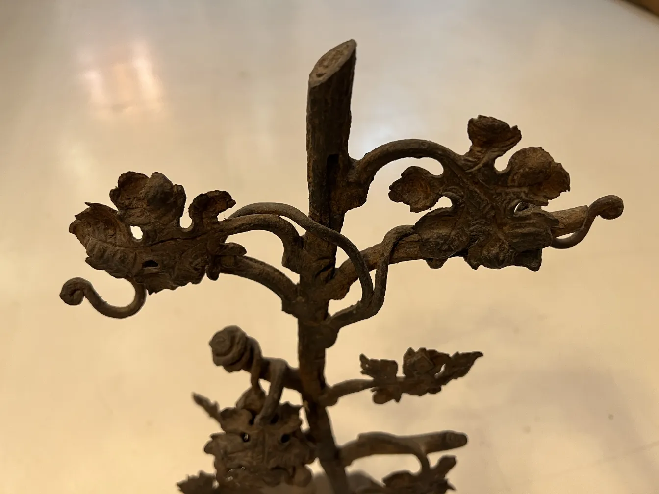 Antique sculpture featuring iron floral and leaf details.