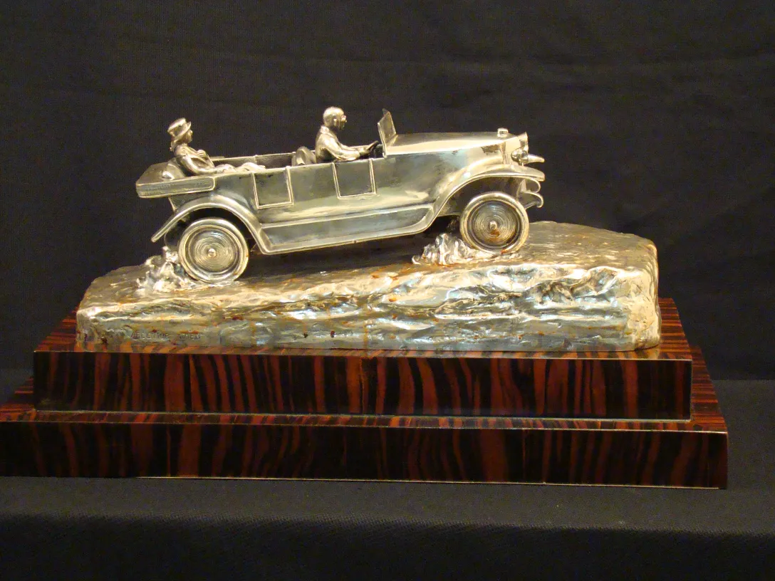 antique sculpture from Argentor Wien featuring a car figure