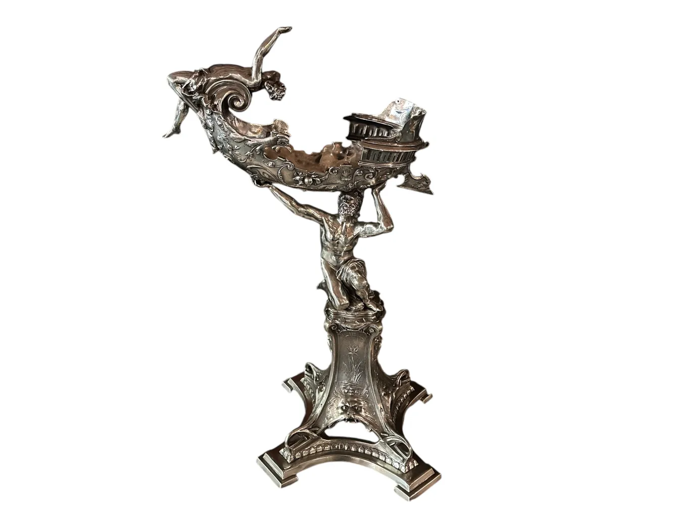 Antique sculpture featuring mythological figures with intricate designs