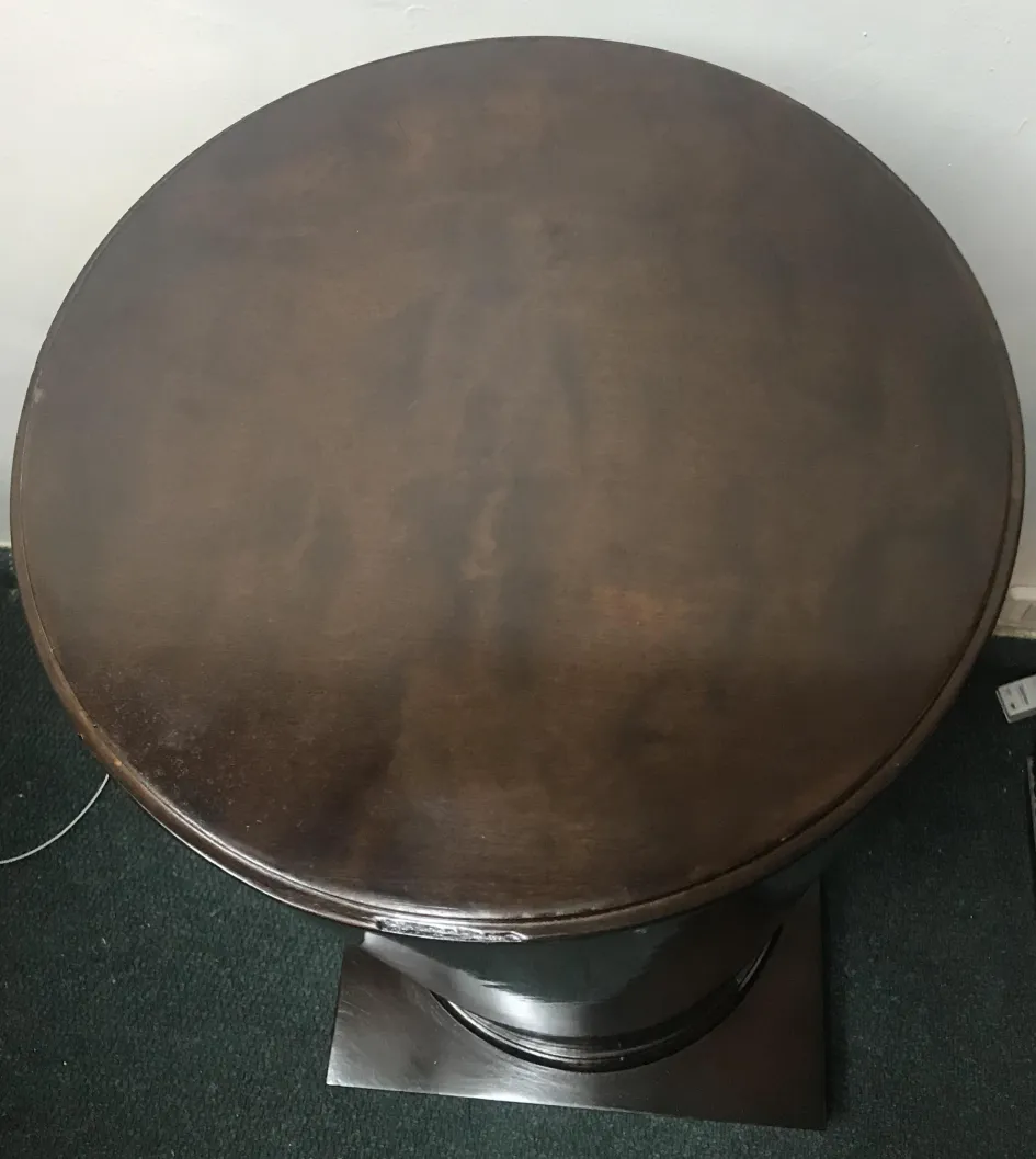 top view of an antique circular column with base, neutral background