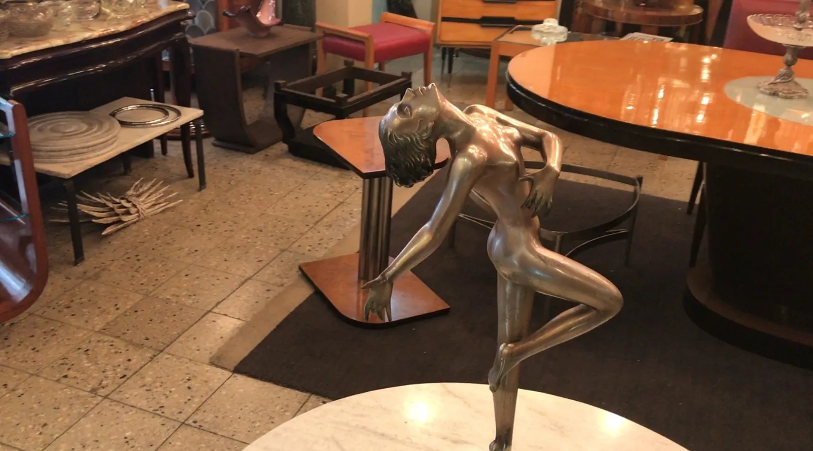 escultura antigua de figura humana en movimiento, entorno elegante