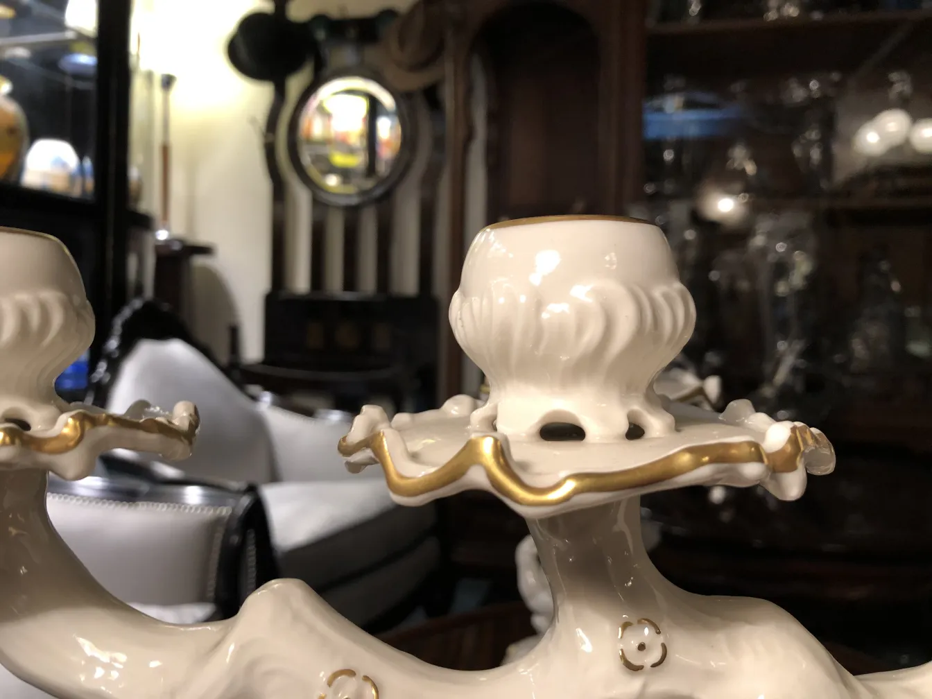 Antique ceramic candlestick with gilded details