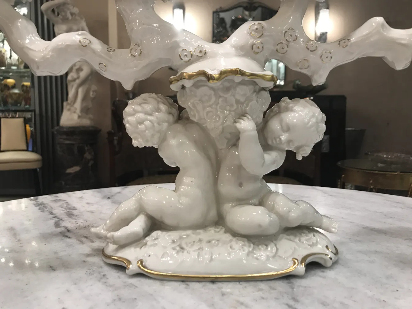 Cerâmica decorativa antiga com figuras brilhantes e ramos.