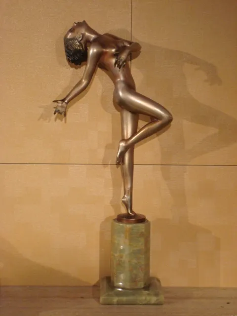 Antique sculpture of an elegant human figure in motion.