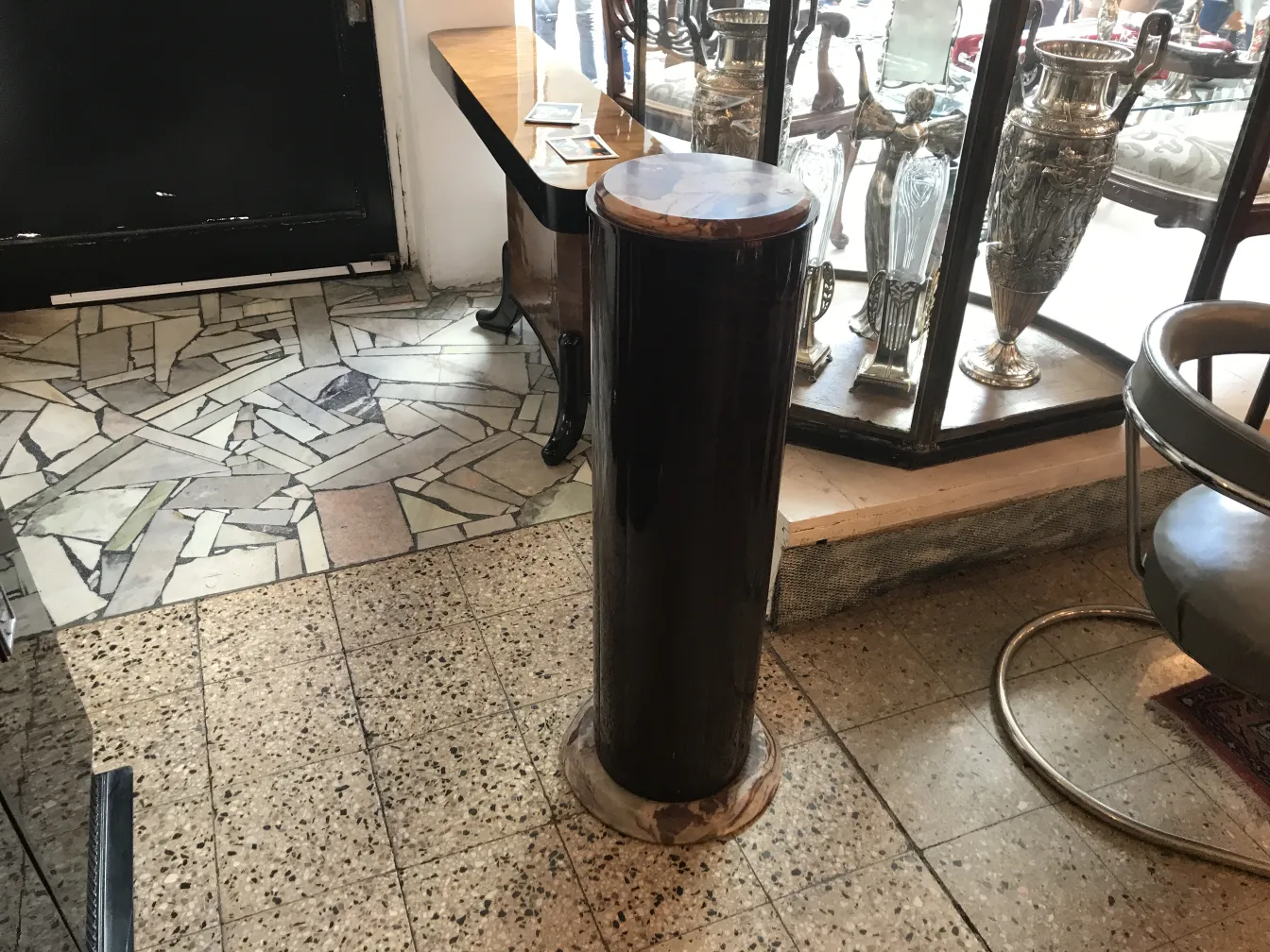 Antique decorative column, situated in an elegant setting.