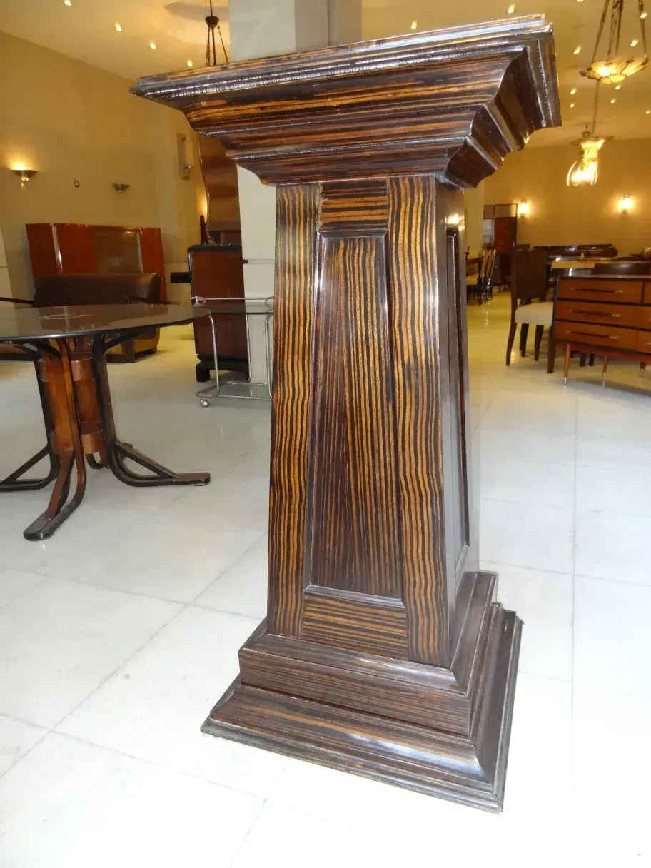 Antique wooden column with striped design, decorative.