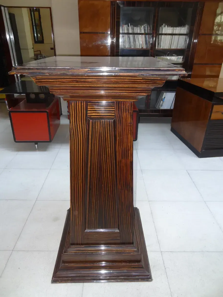 Columna antigua de madera con diseño refinado en un ambiente moderno.