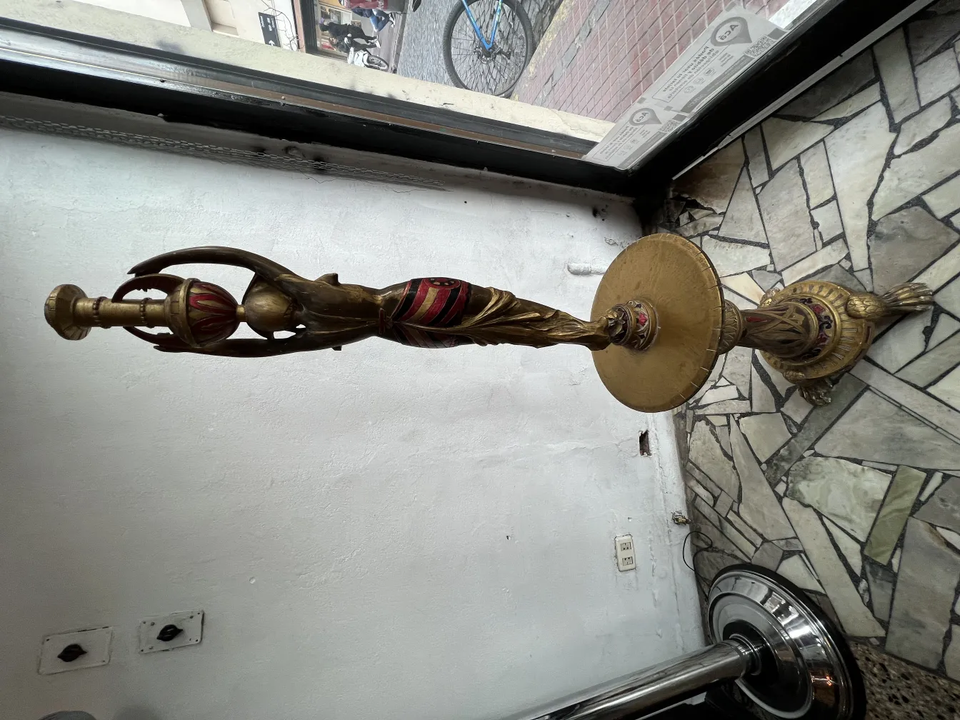 Antique bronze sculpture with red details, elegant and distinctive.