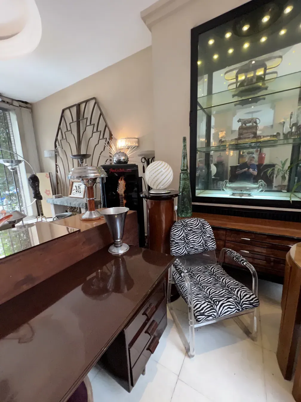 Antique decorative column in an elegant setting with modern furniture.