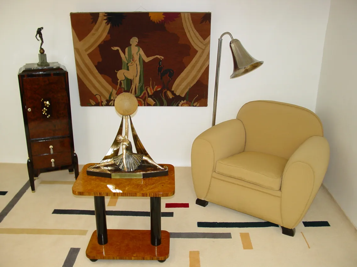 Antique sculpture on coffee table, featuring a dancing figure with gold accents.
