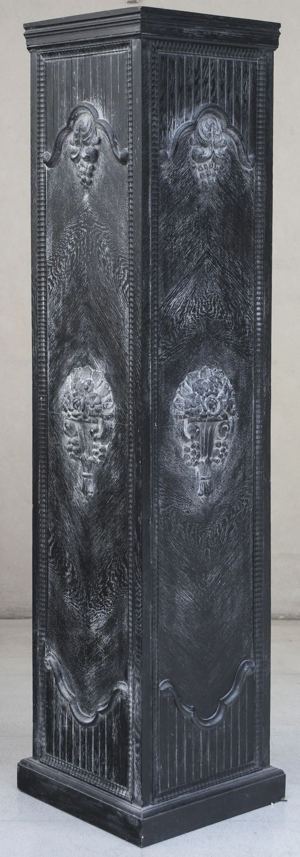 antique black column with grape carvings