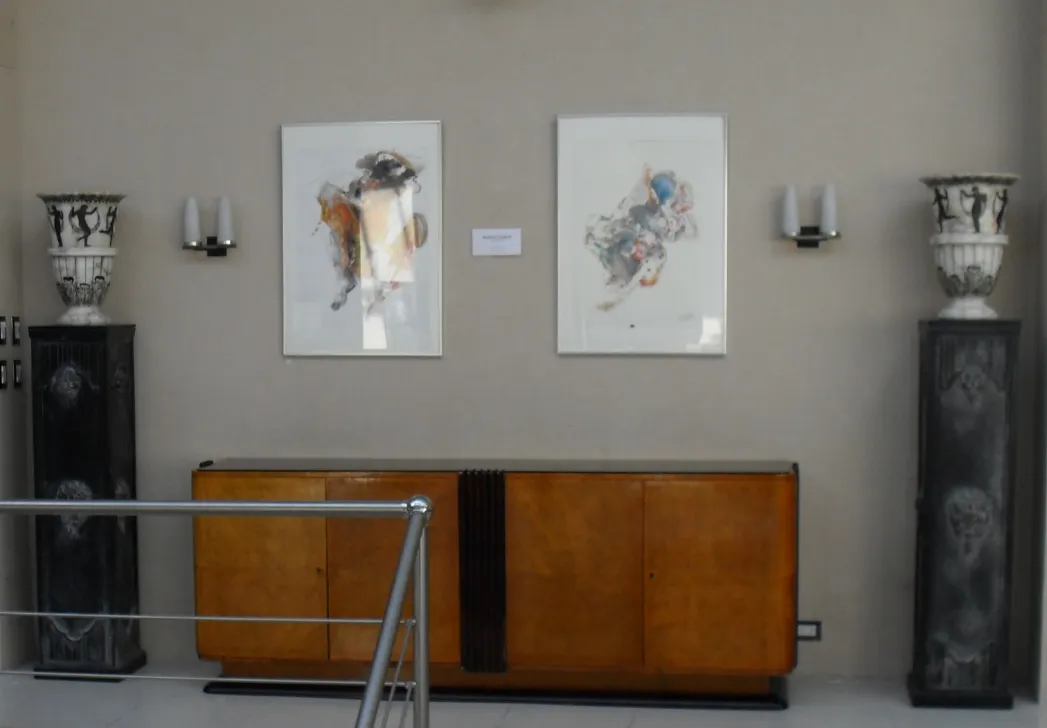 Antique decorative column next to modern art pieces