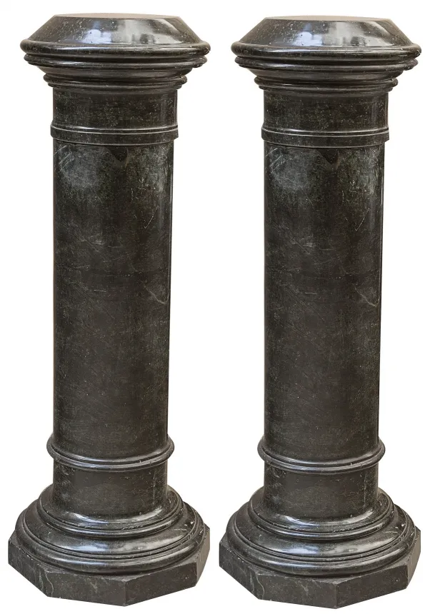 Two antique dark columns with wide bases