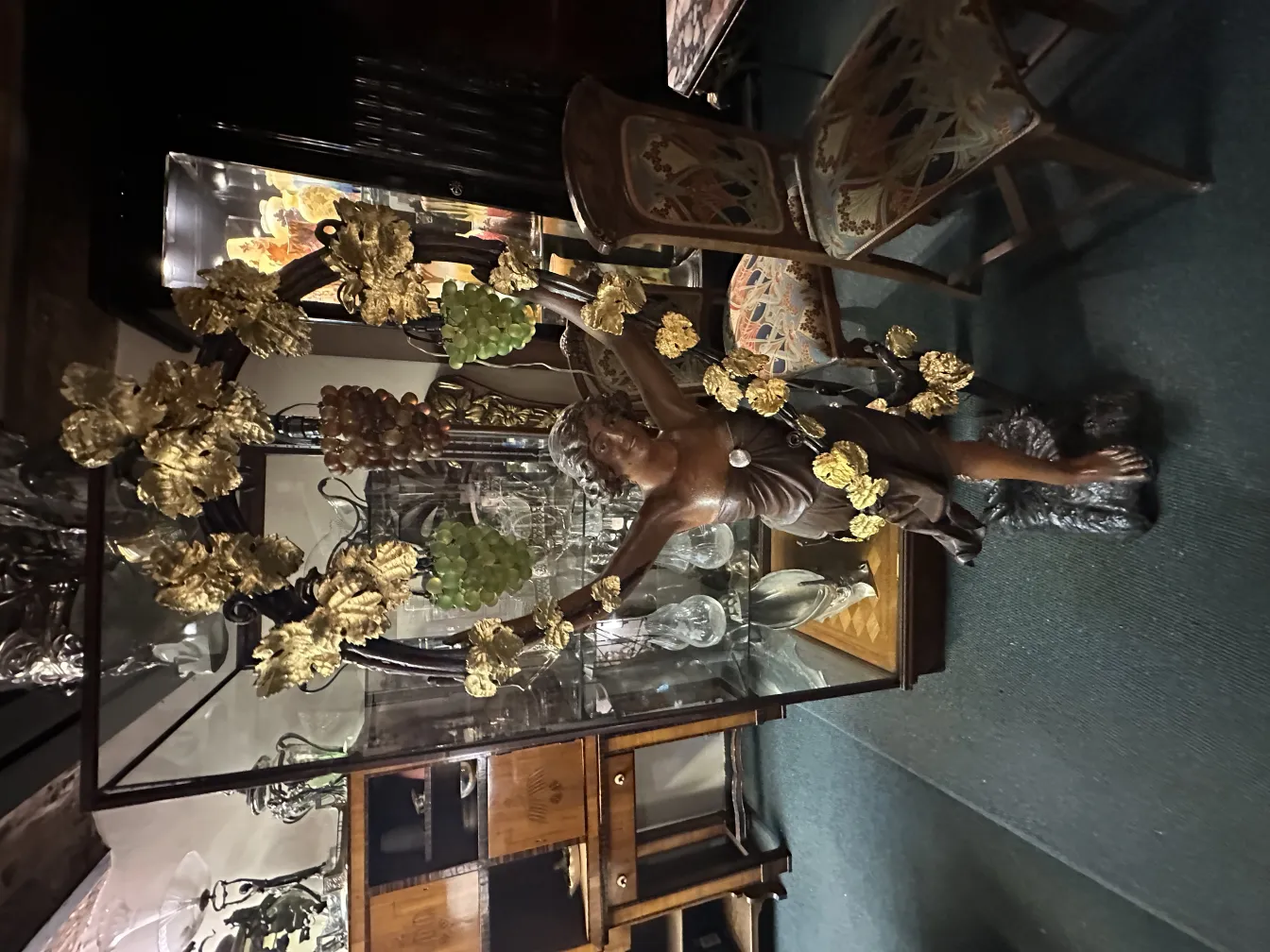 antique decorative sculpture of a figure with golden leaves in an antique background