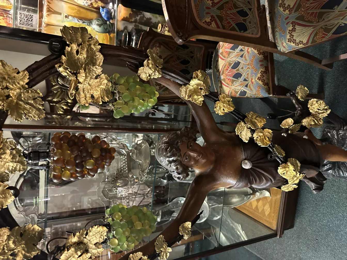 ancient sculpture of a man surrounded by golden leaves and grapes