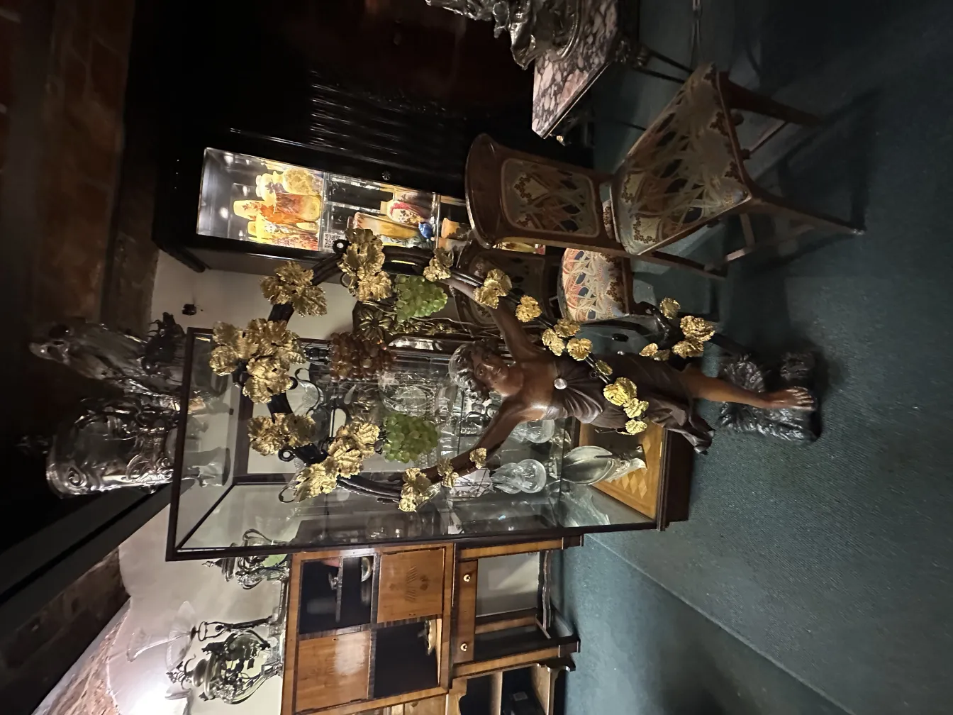 Ancient sculpture depicting gods surrounded by golden leaves