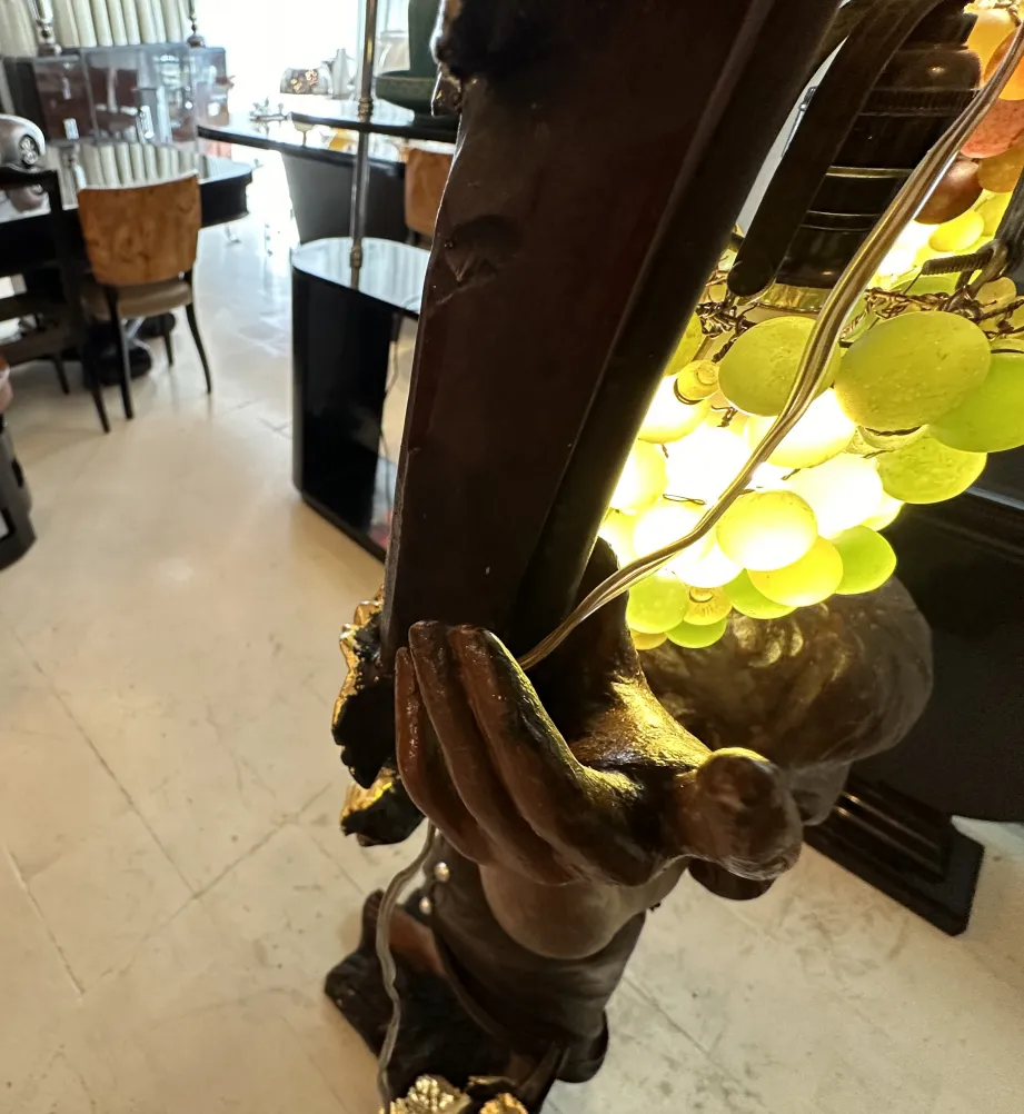 Antique sculpture of a hand holding a decorative object.