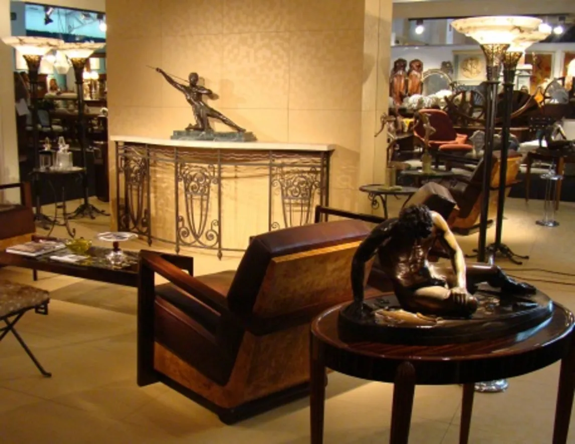 antique sculpture of a seated man, elegant setting
