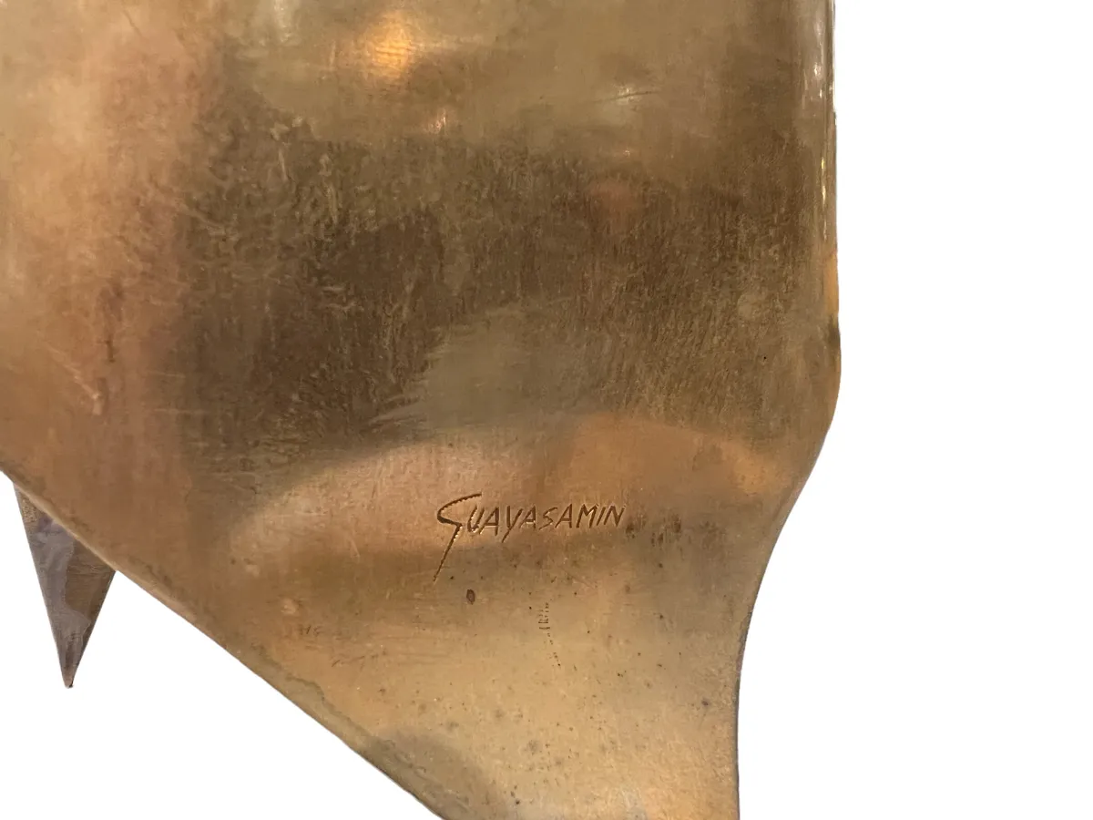 ancient bronze sculpture with an abstract shape in a stylish setting