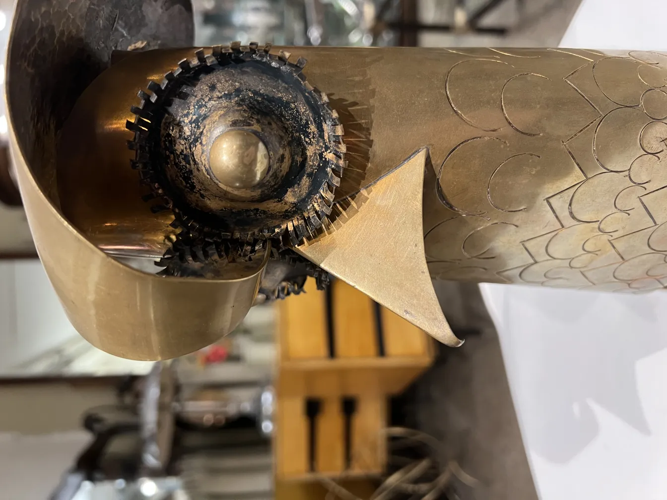 scultura antica con dettagli decorativi in metallo e ingranaggi visibili